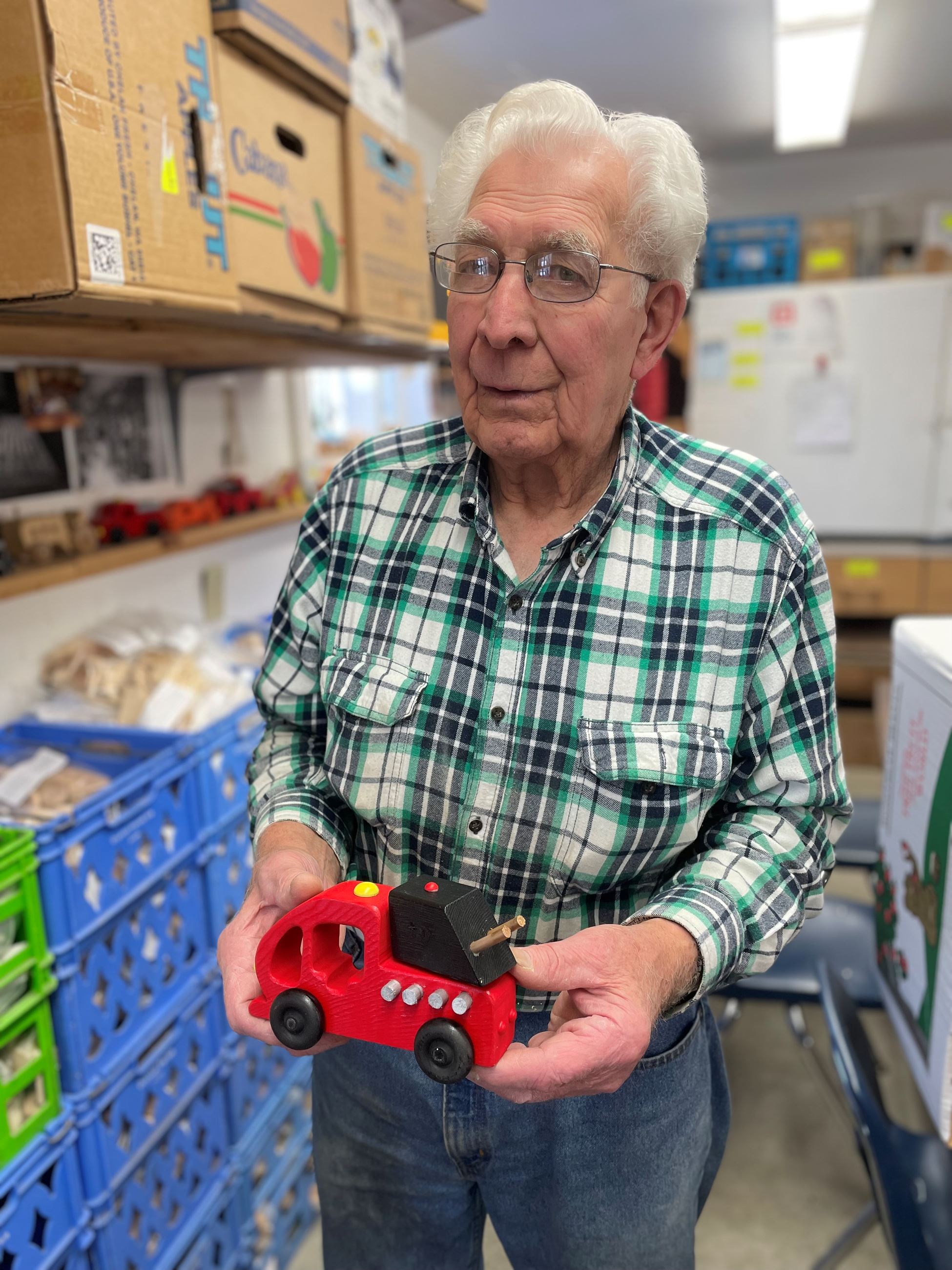 Lee holding a wooden toy fire truck