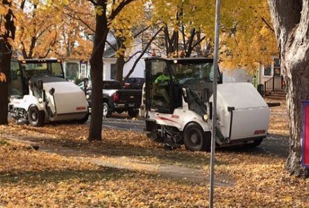 Street sweepers clean streets in the fall